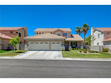 Charming two-story home with a well-manicured lawn and a three car garage at 1316 Borderwood Ln, North Las Vegas, NV 89031