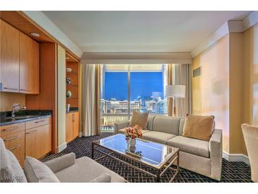 Comfortable living room with large window offering a stunning city view at night at 2000 Fashion Show Dr # 4105, Las Vegas, NV 89109