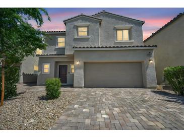 Charming two-story home with a two-car garage and desert landscaping at 2024 Mystic Wave Rd, North Las Vegas, NV 89031
