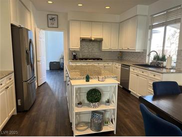 Bright kitchen with white cabinets, stainless steel appliances, and a stylish center island at 2229 Armacost Dr, Henderson, NV 89074