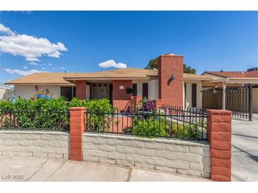 Charming single-story home featuring a well-kept front yard and a classic brick chimney at 2254 Florence Ave, Las Vegas, NV 89119