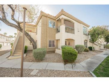 Beautiful two-story condo featuring a private balcony, lush landscaping, and a convenient stairway entrance at 6808 Indian Chief Dr # 204, Las Vegas, NV 89130