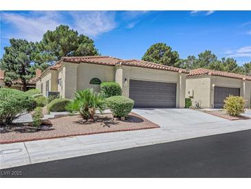 Charming single-story home with a two-car garage, beautiful landscaping, and a tile roof at 7909 Canoe Ln, Las Vegas, NV 89145