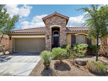 Charming single-story home featuring a stone facade, two-car garage, and drought-tolerant landscaping at 10381 Borah Park Cir, Las Vegas, NV 89178