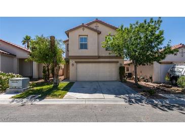 Two-story home with a two car garage and a well-manicured lawn at 11147 Verismo St, Las Vegas, NV 89141