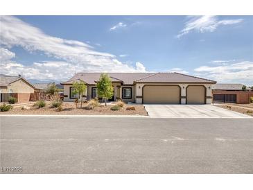 Charming single-story home featuring a three-car garage and low-maintenance desert landscaping at 171 Weeping Willow Ct, Pahrump, NV 89048