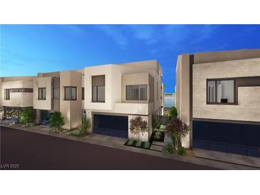 Modern home boasts sleek design, glass garage door, manicured landscaping and inviting curb appeal at 20 Lakefront Dr, Henderson, NV 89011