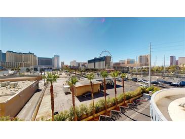 Expansive city view showcasing palm trees, buildings, and a clear blue sky, creating an appealing urban landscape at 211 E Flamingo Rd # 202, Las Vegas, NV 89169