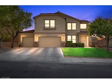 Charming two-story home featuring a three-car garage and well-manicured front lawn at twilight at 249 Cinnamon Ridge Way, Henderson, NV 89015