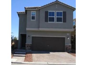 Two-story home showcasing neutral paint, a dark brown garage door, and manicured landscaping at 7705 Alder Forest St, Las Vegas, NV 89113