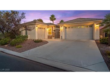 Charming single-story home with a well-manicured yard, desert landscaping, and multi-car garage at 8623 Kennedy Heights Ct, Las Vegas, NV 89131