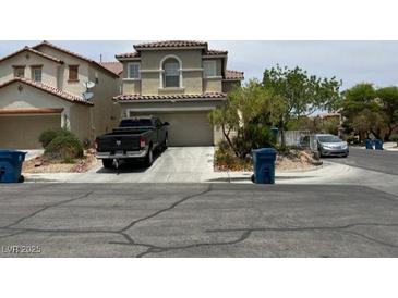 Two-story stucco home featuring a well-maintained yard and attached garage on a sunny day at 9564 Fresh Crown Ct, Las Vegas, NV 89148