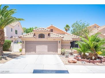 Charming single-story home with a well-manicured front yard, desert landscaping, and a two-car garage at 9632 Spanish Steps Ln, Las Vegas, NV 89117