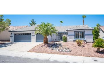 Charming single-story home with a two-car garage and desert landscaping in the front yard at 9728 Drumcannon Ave, Las Vegas, NV 89129