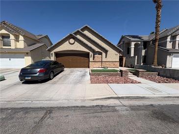 Charming single-story home featuring a well-manicured yard and a spacious two-car garage at 3078 Kennewick Dr, Las Vegas, NV 89121