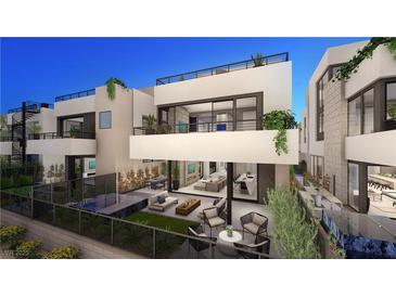 Stunning modern home with a large patio, outdoor seating, and a glimpse of the open-concept interior at 32 Heron Harbour Dr, Henderson, NV 89011