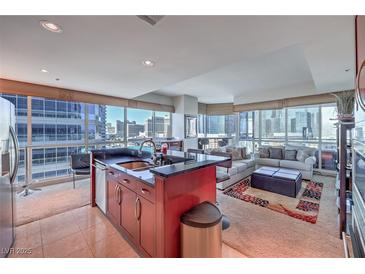 Bright, open living space featuring floor-to-ceiling windows with stunning city views and modern furnishings at 4575 Dean Martin Dr # 1112, Las Vegas, NV 89103