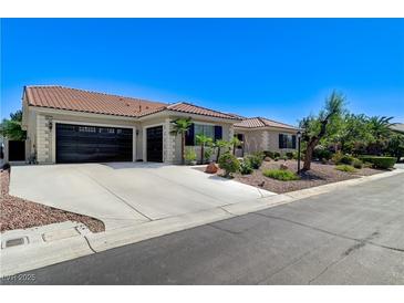 Charming home featuring a spacious driveway and a well-manicured front yard landscape at 5913 Audria Falls Ave, Las Vegas, NV 89131