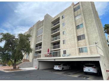 Multi-story condo complex featuring balconies and covered parking at 745 N Royal Crest Cir # 157, Las Vegas, NV 89169
