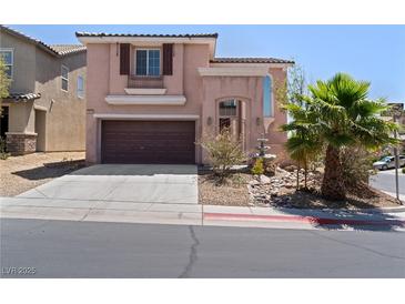 Charming home featuring a well-manicured front yard with a two car garage and desert landscaping at 10478 Beallsville St, Las Vegas, NV 89141