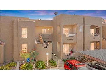 Inviting two-story condo showcasing well-maintained landscaping and a charming facade at 2243 Aspen Mirror Way # 102, Laughlin, NV 89029
