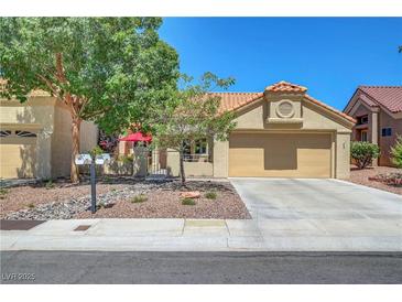 Charming single-story home featuring a well-maintained lawn, desert landscaping, and a spacious two-car garage at 2456 Desert Butte Dr, Las Vegas, NV 89134