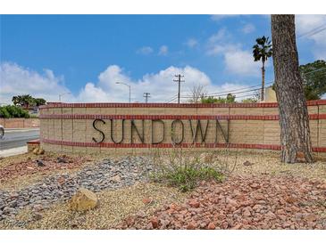 Sundown community entrance sign, featuring desert landscaping, a brick base, and clear blue skies at 4036 Nightingale Ct, Las Vegas, NV 89107