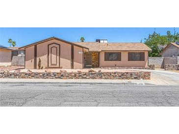 Charming single-story home featuring desert landscaping and a stone accent wall for added curb appeal at 4784 El Escorial Dr, Las Vegas, NV 89121