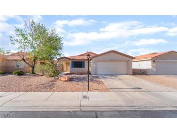 Charming single-story home with desert landscaping, a two-car garage, and a neatly maintained front yard at 5009 Peaceful Pond Ave, Las Vegas, NV 89131