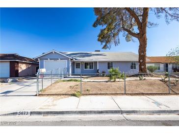 Charming single story home featuring a xeriscaped front yard and mature tree at 5673 Coaldale Pl, Las Vegas, NV 89110