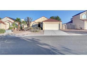 Charming single-story home with desert landscaping and a two-car garage on a sunny day at 641 Bay Bridge Dr, North Las Vegas, NV 89032