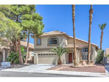 Charming two-story home featuring a well-manicured front yard and attached two-car garage at 8712 Texas Bronco Ave, Las Vegas, NV 89129