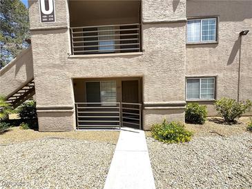 Inviting exterior of this home featuring stone landscaping, tan stucco and well-maintained walkways at 9070 Spring Mountain Rd # 109, Las Vegas, NV 89117