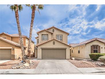 Charming two-story home featuring a two-car garage and desert landscaping at 9129 Patrick Henry Ave, Las Vegas, NV 89149