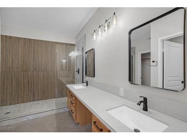 Modern bathroom featuring a double vanity, sleek fixtures, and a stylish tiled shower at 913 Duckhorn Ct # 201, Las Vegas, NV 89144