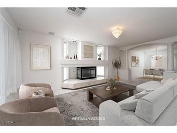 Bright living room showcases modern fireplace, neutral tones, and elegant decor for a cozy and stylish space at 9604 Summer Cypress St, Las Vegas, NV 89123