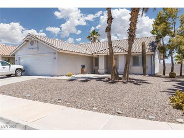 Charming single-story home with desert landscaping, tiled roof, and a two-car garage at 998 Hunters Run Dr, Henderson, NV 89002