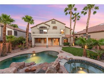 Beautiful backyard featuring a pool, spa, patio, landscaping, and palm trees with a view of the home at 2221 Grier Woods Ct, Las Vegas, NV 89134