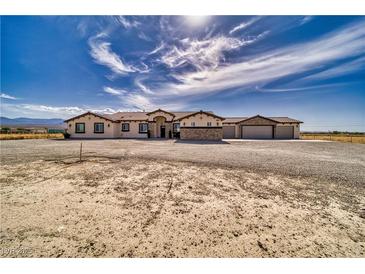 Expansive home featuring an attached three car garage and drought resistant landscaping at 3301 Underbrush Ave, Pahrump, NV 89048