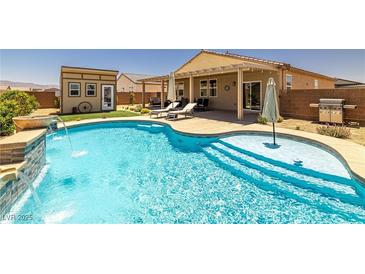 A beautiful in-ground pool featuring an attached spa, tanning deck, and covered outdoor living area at 3568 E Malheur Ave, Pahrump, NV 89061