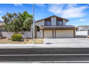 Two-story home featuring a two-car garage and solar panels at 3746 E Harmon Ave, Las Vegas, NV 89121