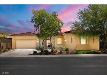 Charming single-story home featuring a well-manicured front yard and neutral stucco exterior in a gated community at 7914 Elk Mountain St, Las Vegas, NV 89113
