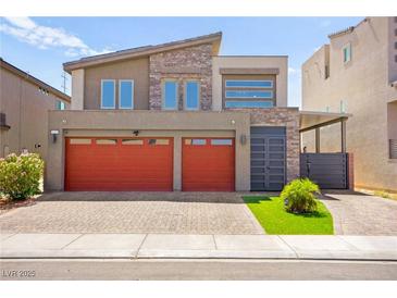 Modern two-story home with brick driveway, a two-car garage and stone accents at 8955 Ruby Moon Dr, Las Vegas, NV 89139