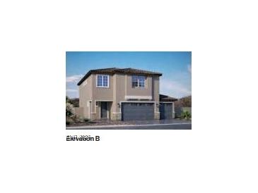 Two-story home featuring a three car garage and desert landscaping at 1198 Dre Harbor Pl. Ln # 86, North Las Vegas, NV 89084