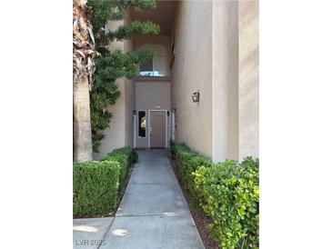 Inviting walkway leading to the front door with manicured landscaping at 2050 W Warm Springs Rd # 4021, Henderson, NV 89014