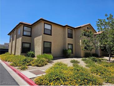 Two story home with manicured lawn and flowers at 2451 N Rainbow Blvd # 1123, Las Vegas, NV 89108