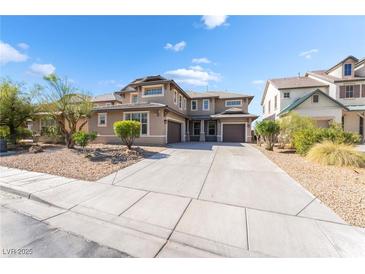 Beautiful two-story home featuring a three-car garage and desert landscaping at 2625 Cattrack Ave, North Las Vegas, NV 89081