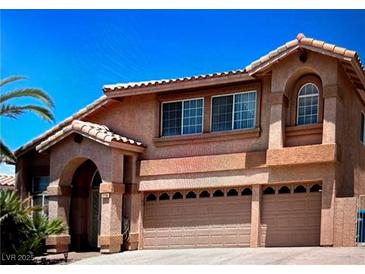 Inviting two-story home with a three-car garage and a landscaped front yard at 2728 Aspen Wood Ave, Henderson, NV 89074