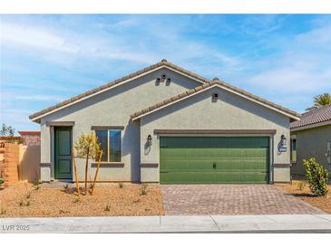 Charming single-story home featuring a quaint front yard and a two-car garage at 4404 Cave Lake Ave, North Las Vegas, NV 89032