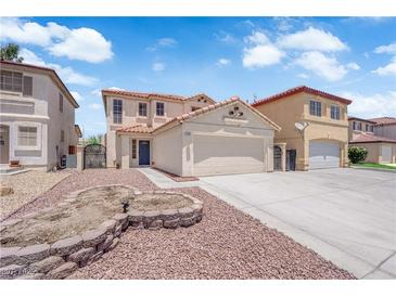 Charming two-story home with a red rock landscaped yard and neutral paint at 638 Ribbon Grass Ave, Las Vegas, NV 89183